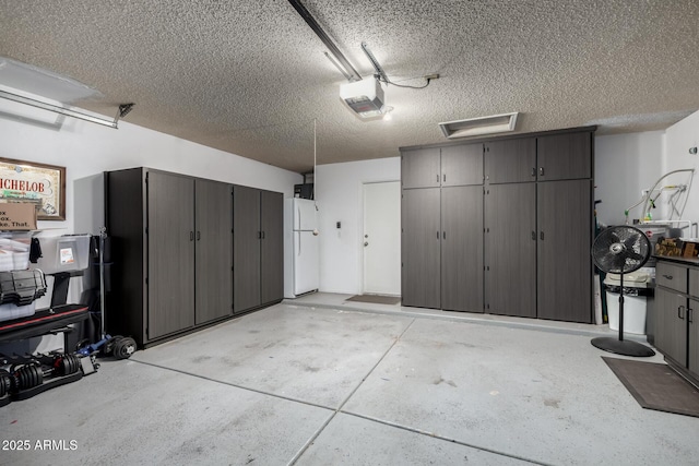 garage with white refrigerator and a garage door opener