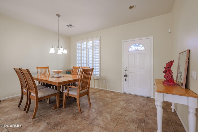 dining room featuring light tile patterned floors and a chandelier