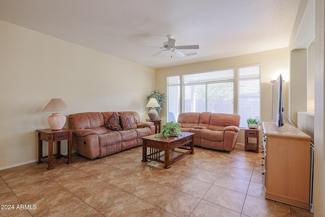 living room with ceiling fan and light tile patterned flooring