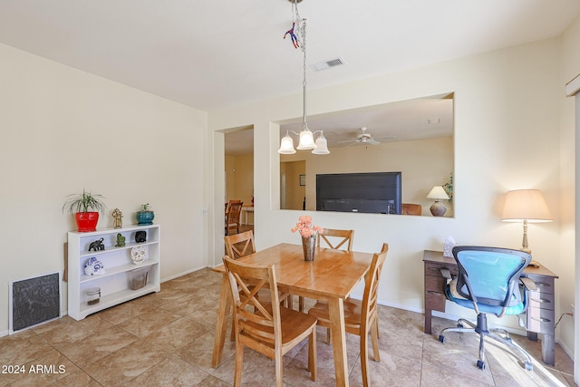 dining space featuring ceiling fan with notable chandelier