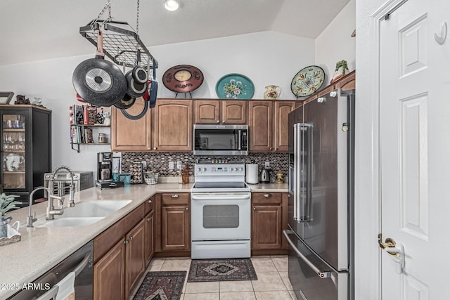 3755 E Hazeltine Way, Chandler, AZ 85249 - kitchen featuring appliances with stainless steel finishes, a sink, lofted ceiling, light countertops, and light tile patterned floors