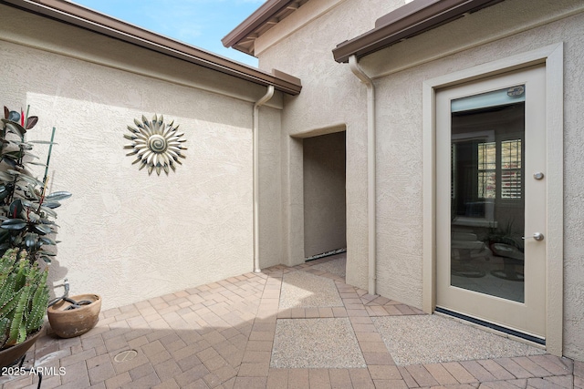 property entrance featuring stucco siding