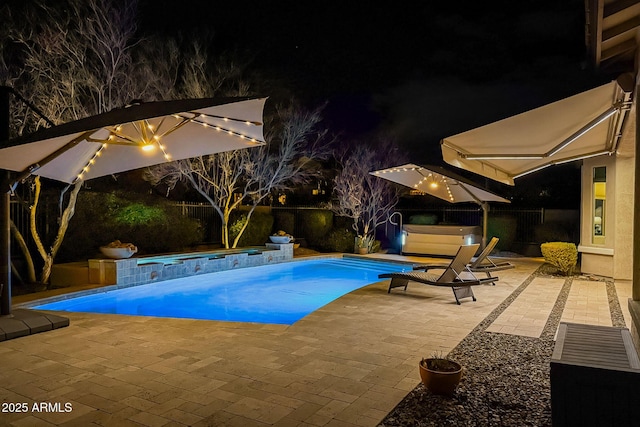 pool at twilight with a hot tub, a fenced in pool, and a patio