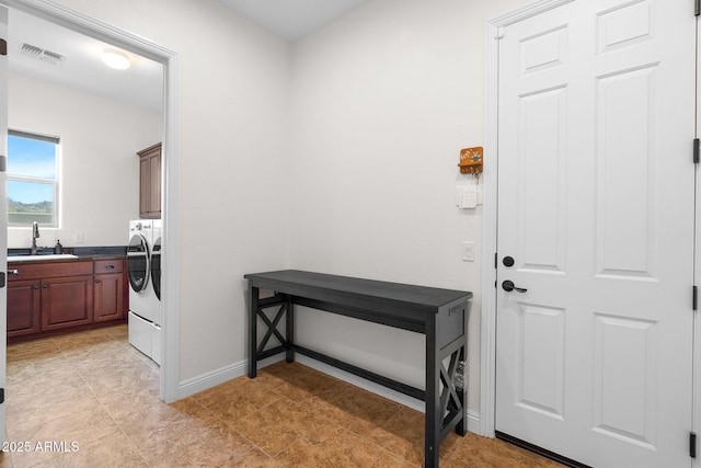 interior space with washing machine and dryer, visible vents, and baseboards