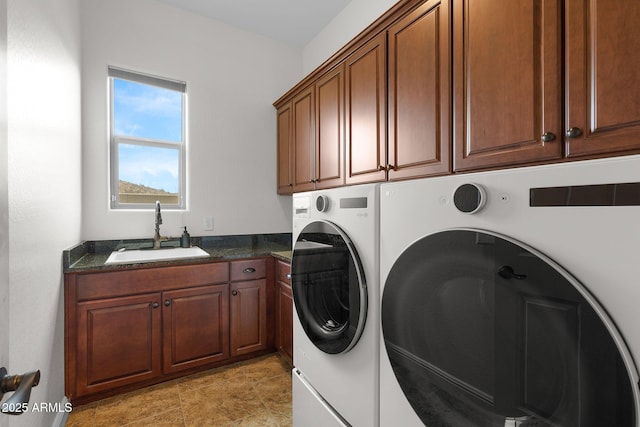 clothes washing area with independent washer and dryer, a sink, and cabinet space