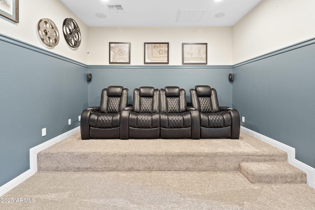 carpeted cinema room with visible vents and baseboards