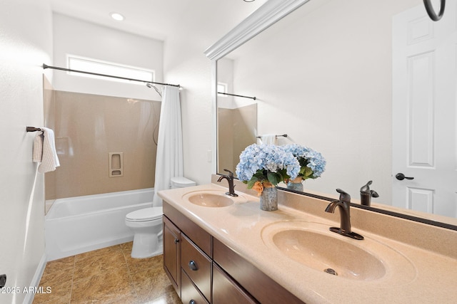 bathroom featuring double vanity, shower / bath combo with shower curtain, a sink, and toilet