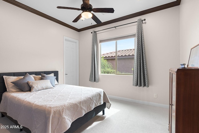 carpeted bedroom featuring baseboards, a ceiling fan, and crown molding