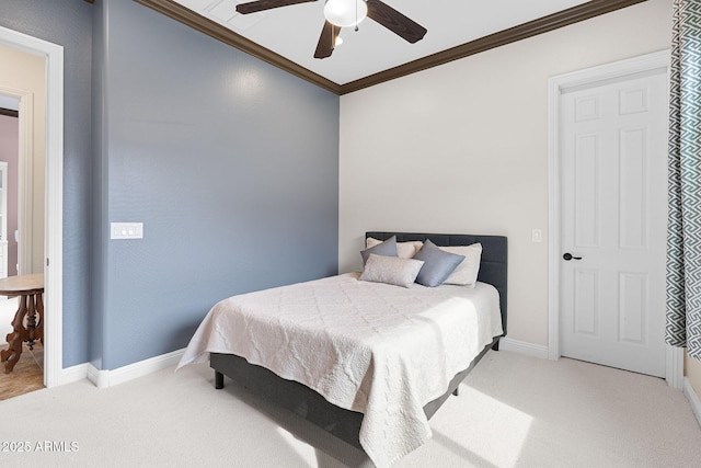 carpeted bedroom with ceiling fan, ornamental molding, and baseboards