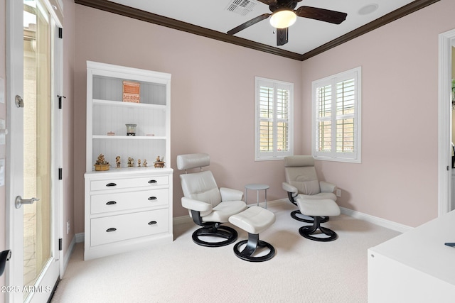 sitting room featuring light carpet, a ceiling fan, visible vents, baseboards, and ornamental molding