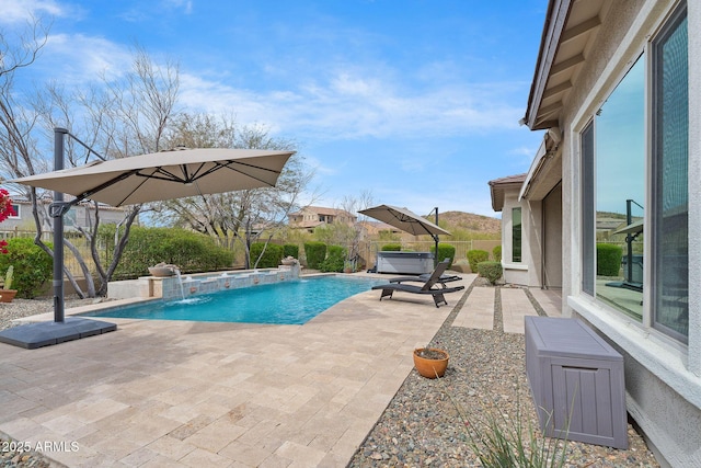 view of pool with a patio area, a hot tub, fence, and a fenced in pool