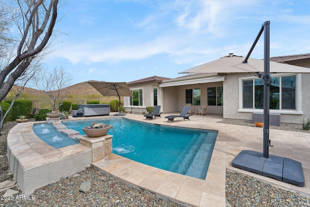 view of swimming pool with a patio area, fence, a fenced in pool, and a hot tub