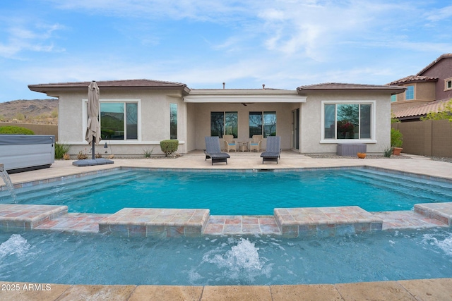 view of pool featuring a pool with connected hot tub, a patio area, fence, and central AC unit