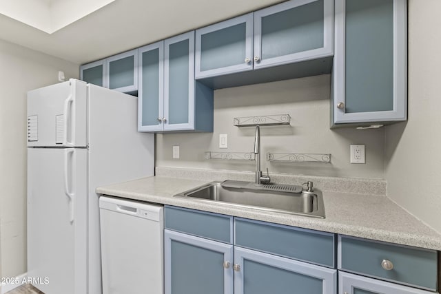 1927 E Hampton Ave Unit 204, Mesa, AZ 85204 - kitchen with white appliances, blue cabinetry, light countertops, and glass insert cabinets