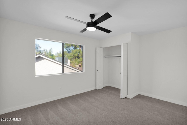 unfurnished bedroom featuring carpet floors, a closet, and ceiling fan