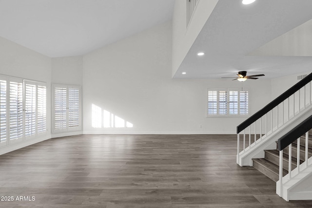 unfurnished living room with ceiling fan, plenty of natural light, and dark hardwood / wood-style floors