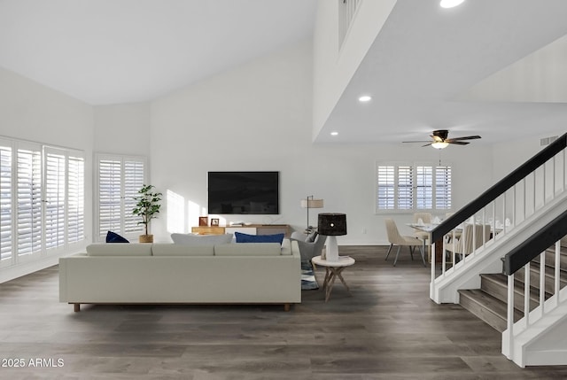 living room featuring ceiling fan and dark wood-type flooring