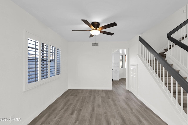 unfurnished living room featuring hardwood / wood-style floors, ceiling fan, and a healthy amount of sunlight