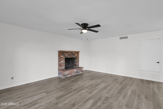 unfurnished living room with a fireplace, hardwood / wood-style floors, and ceiling fan