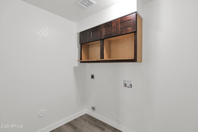 laundry room with hookup for an electric dryer, washer hookup, gas dryer hookup, and dark wood-type flooring