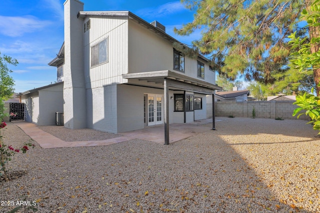 back of property with a patio and french doors