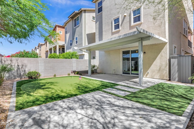 751 W Flintlock Way, Chandler, AZ 85286 - rear view of house featuring a putting green, a patio, stucco siding, and a residential view