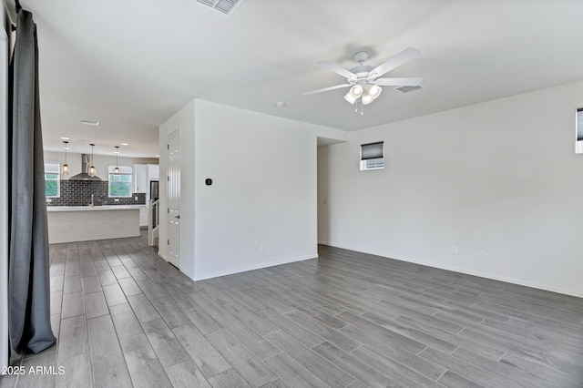 751 W Flintlock Way, Chandler, AZ 85286 - spare room with a ceiling fan, wood finished floors, and baseboards