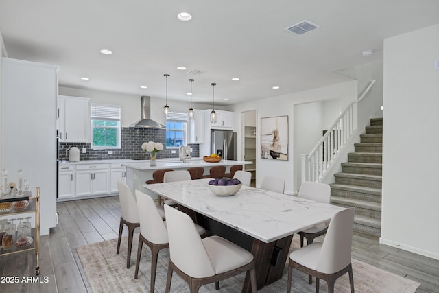 751 W Flintlock Way, Chandler, AZ 85286 - dining space with light wood-type flooring, recessed lighting, and stairway