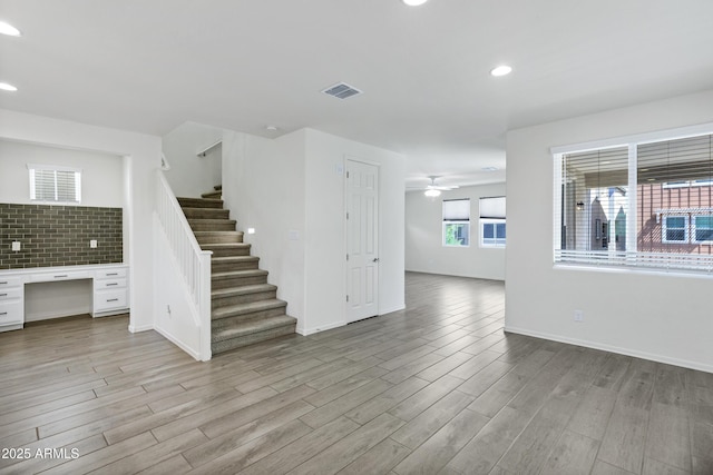 751 W Flintlock Way, Chandler, AZ 85286 - unfurnished living room with light wood-type flooring, stairs, a ceiling fan, recessed lighting, and baseboards