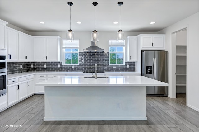 751 W Flintlock Way, Chandler, AZ 85286 - kitchen with appliances with stainless steel finishes, a sink, a kitchen island with sink, light wood-style flooring, and recessed lighting