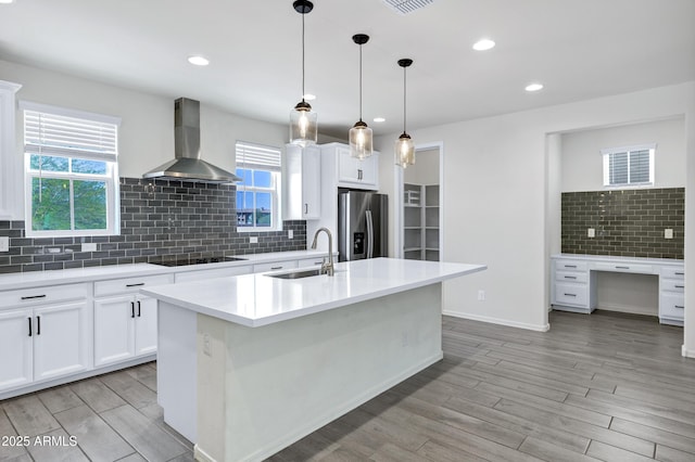 751 W Flintlock Way, Chandler, AZ 85286 - kitchen featuring a sink, wall chimney range hood, stainless steel fridge, black electric cooktop, and decorative backsplash