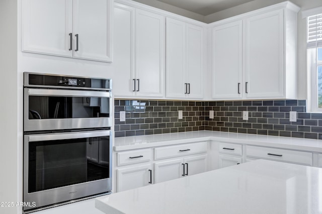 751 W Flintlock Way, Chandler, AZ 85286 - kitchen featuring double oven, light countertops, white cabinetry, and decorative backsplash