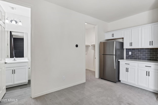 751 W Flintlock Way, Chandler, AZ 85286 - kitchen featuring freestanding refrigerator, white cabinets, light carpet, and light countertops