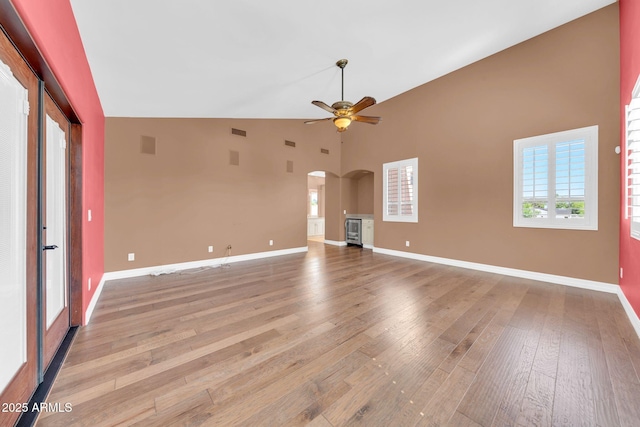 1435 E Rancho Dr, Phoenix, AZ 85014 - unfurnished living room with ceiling fan, visible vents, arched walkways, light wood-type flooring, and baseboards