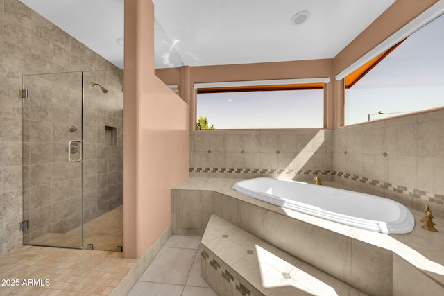 1435 E Rancho Dr, Phoenix, AZ 85014 - full bath with tile patterned floors, plenty of natural light, a shower stall, and a bath