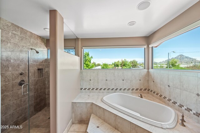1435 E Rancho Dr, Phoenix, AZ 85014 - bathroom with tile patterned flooring, a shower stall, a wealth of natural light, and a bath