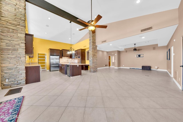 1435 E Rancho Dr, Phoenix, AZ 85014 - kitchen featuring stainless steel appliances, open floor plan, ceiling fan with notable chandelier, and high vaulted ceiling