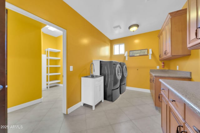 1435 E Rancho Dr, Phoenix, AZ 85014 - clothes washing area featuring cabinet space, independent washer and dryer, baseboards, and light tile patterned floors