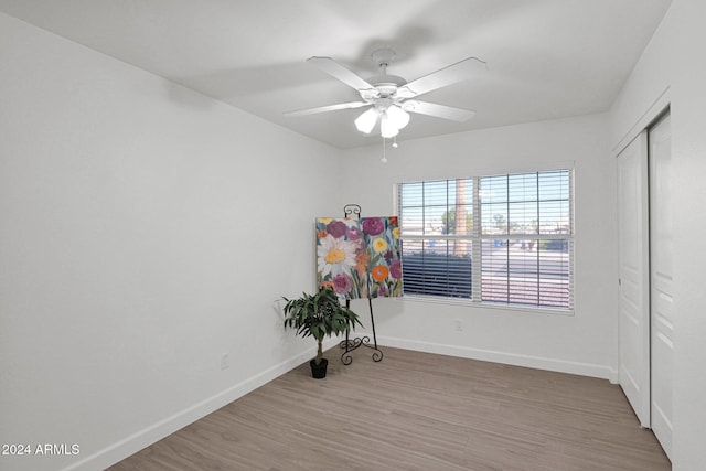 spare room with ceiling fan and hardwood / wood-style flooring