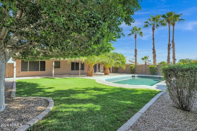 view of swimming pool featuring a patio and a lawn