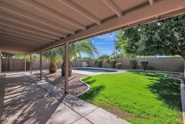 view of yard with a fenced in pool and a patio area