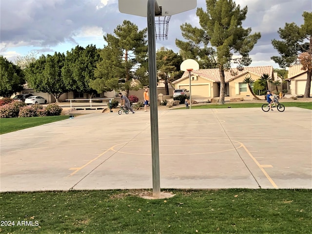 view of home's community featuring basketball hoop