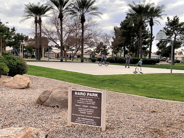 surrounding community with basketball hoop and a yard