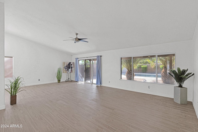 unfurnished living room featuring ceiling fan, wood-type flooring, and vaulted ceiling