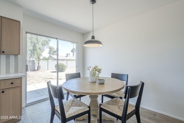 dining area with wood finished floors and baseboards
