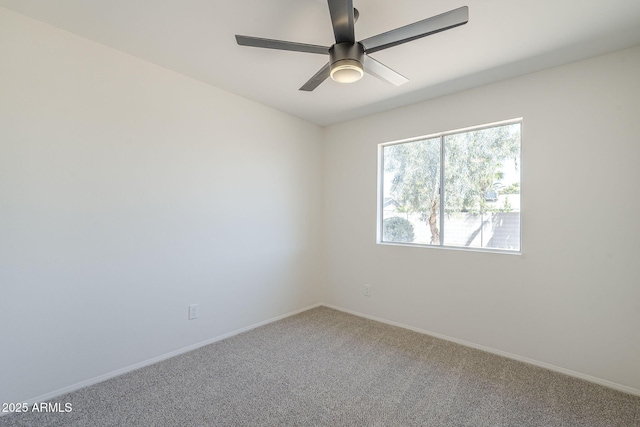 spare room featuring carpet flooring, a ceiling fan, and baseboards