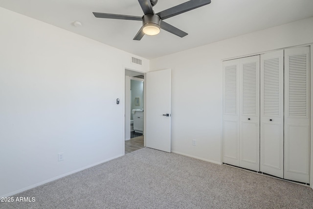 unfurnished bedroom featuring carpet flooring, a closet, baseboards, and a ceiling fan