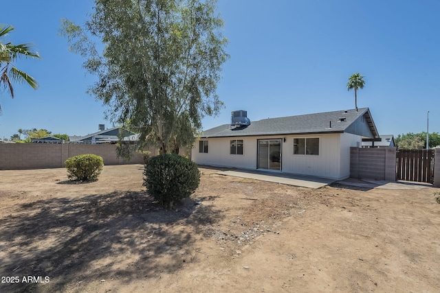 rear view of house featuring a patio and a fenced backyard