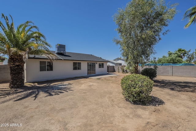 view of front of home featuring a fenced backyard, central air condition unit, and a patio area