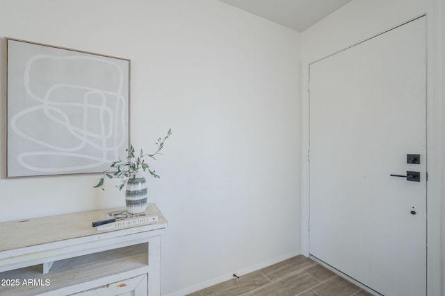 doorway to outside with baseboards and light wood finished floors